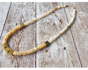 Choker with square brass beads and cream colored rondelle and round shell beads with gold hook clasp